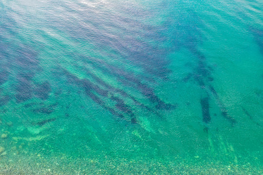 Aerial top down view photo of azure blue ocean waves showing beautiful bright and deep blue color from sea reef shallow water near tropical island popular tourist destination for summer vacation