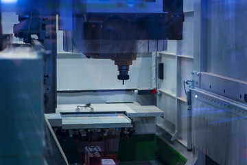 Operator machining automotive part by turning machine, Industry machine background