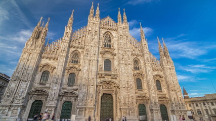 The Duomo cathedral timelapse  at sunset. Front view with people sitting on stairs
