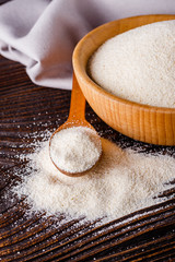 natural organic semolina on dark wooden rustic background