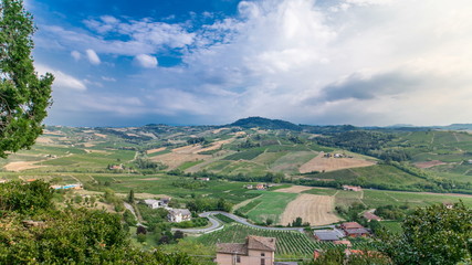 Fototapeta na wymiar view of green summer valley of italian coyntryside timelapse with hills on background