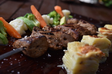grilled shish beef steak with sauce and vegetables