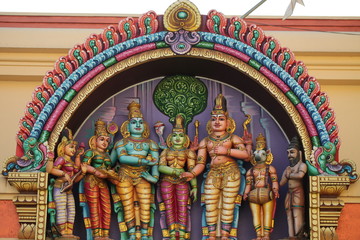 bright figures of the gods on the gopurama of a hindu temple in sri lanka