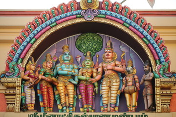 bright figures of the gods on the gopurama of a hindu temple in sri lanka