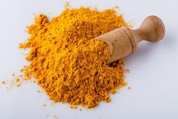 natural turmeric powder on white acrylic background