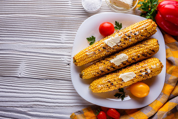 grilled corn cob on white wooden rustic background