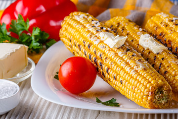 grilled corn cob on white wooden rustic background