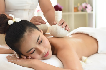 wellness, beauty and relaxation concept - young woman lying on table at spa