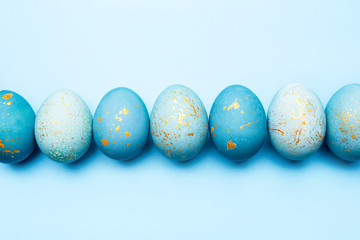 Easter background of eggs painted in blue color. Flat lay, top view.