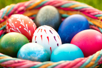 Fototapeta na wymiar Detail of colorful Easter eggs in a wicker basket