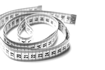 The figure is helix of a centimeter tape. Isolate measuring tape on a white background.