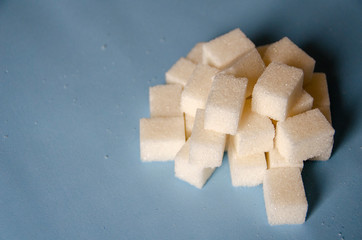 White sweet sugar on a blue background