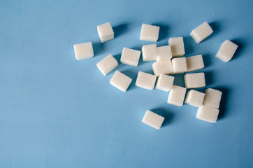 White sweet sugar on a blue background