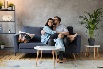 Naklejka premium Young Family Playing Together on the Sofa. happy family. home comfort.