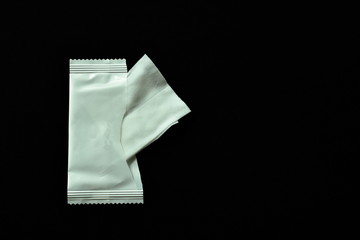white wet tissue fron packinging on black fabric background