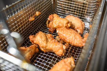 Freshly prepared grilled wings in a grill stove. Fatty food. Tasty food.