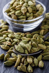 fragrant green cardamom on a dark stone background