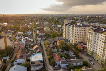 Aerial view of multistory apartment buildings in green residential area.