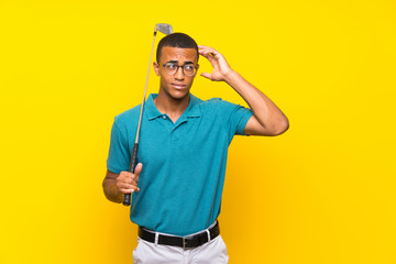 Naklejka premium African American golfer player man having doubts and with confuse face expression