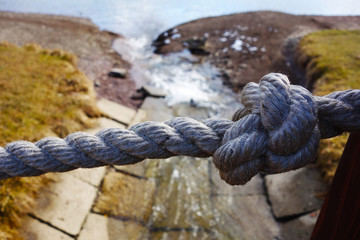 Fototapeta premium Large knot on rope bridge by lake