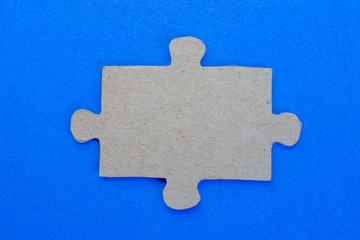 One puzzle on a blue background close-up