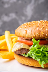 traditional american burger on a gray stone background