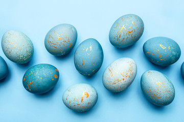 Easter background of eggs painted in blue color. Flat lay, top view.