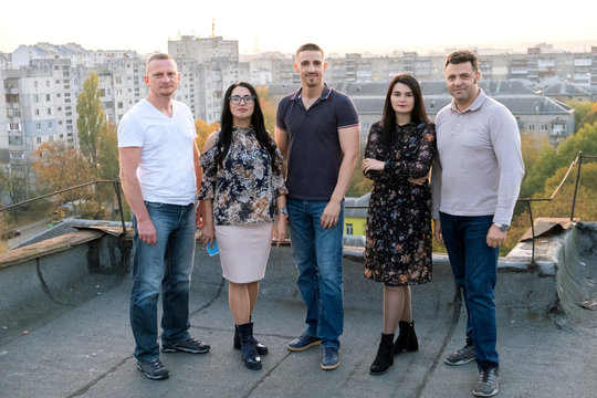 Group of diverce young people standing together outdoors on a wa