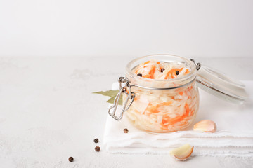 Sauerkraut in a glass jar. Homemade sauerkraut with carrots. Fermented food. Natural probiotic. Copy space for text.