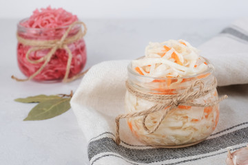 Obraz na płótnie Canvas Homemade sauerkraut salad. Russian, German traditional sour milk cabbage with caraway seeds, spices, pepper, carrots, onions and herbs. Raw vegan healthy food concept.