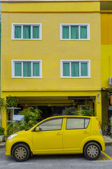 yellow car near the yellow house