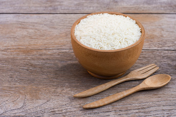 White rice  isolated on wood table background.
