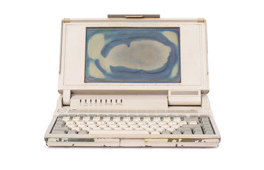 Old laptop computer or portable personal computer isolated on white background with clipping path. Front view. Vintage 90s technology concept.