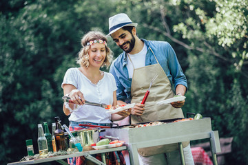 Friends making barbecue and having lunch