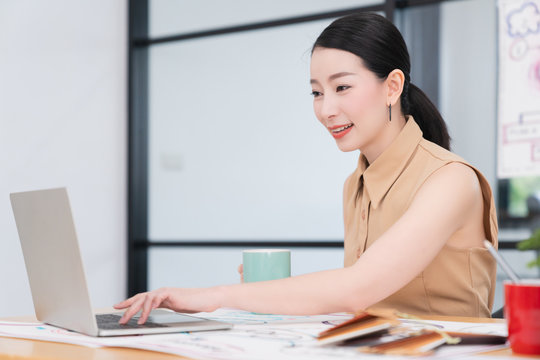 successful leadership smart attractive asian female working with laptop confident and cheerful smile office background