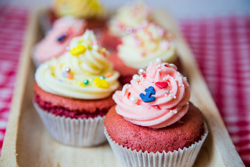 Fototapeta na wymiar Red velvet cupcakes mit Buttercream Topping und Sprinkles