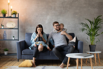 Obraz premium Young Family Playing Together on the Sofa. happy family. home comfort.