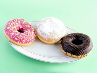 various multicolor tasty doughnuts as tasty confecioneries