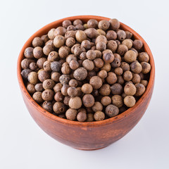 fresh spicy peppers allspice on white acrylic background