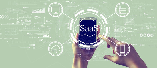 SaaS - software as a service concept with person holding a white smartphone