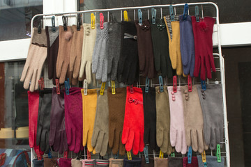 many colorful women's bright gloves in the showcase of a open-air local market