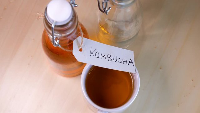 Handwritten label on a bottle of homemade Kombucha. It is a fermented drink made from tea and lemon, produced using culture SCOBY