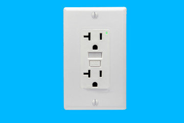 Socket with fuse and with indicator light, shot against the light blue wall of the apartment