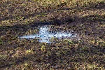 A white painted cross x mark on the ground