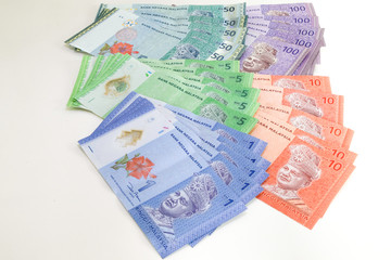 Malaysia Currency (MYR): Stack of Ringgit Malaysia bank note. There is a Malaysia banknotes in (MYR)1, (MYR)5, (MYR)50 and (MYR)100 isolated on white background