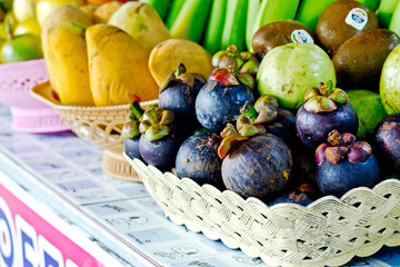 mangosteen on a market counter, delicious asian fruit
