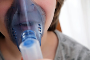 sick teengae girl using a nebulizer