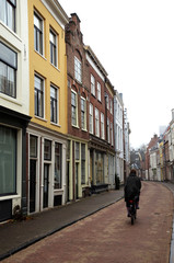 Fototapeta na wymiar Man riding a bike on a Utrecht street