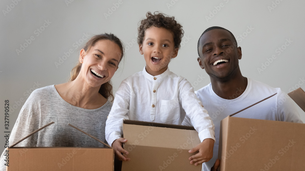 Wall mural Headshot portrait happy African American family with cardboard boxes