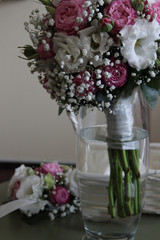 bouquets of brides and bridesmaids from white roses and red peonies, white eustomas and gypsophila